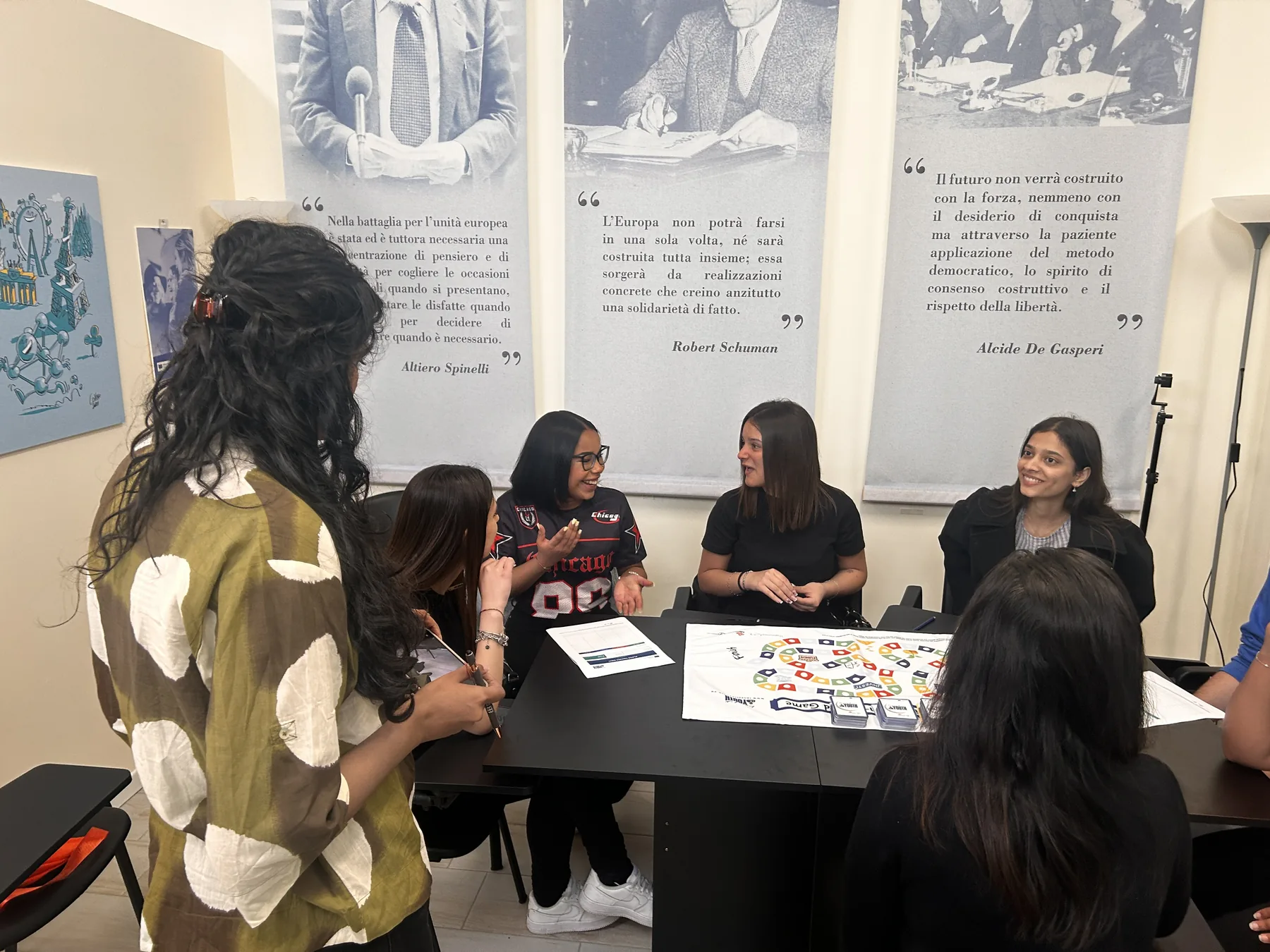 Participants seated around a table with the Invest in Youth board game during the international training in Caserta.
