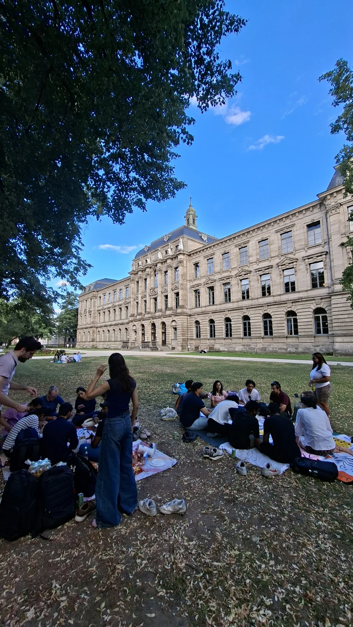The multiplier gathering on the lawn in front of a historic building in Erlangen.